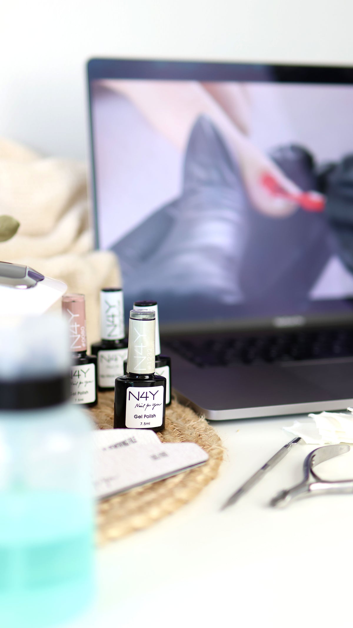 Neglesæt med UV-lampe, gel polish og laptop med neglekursus